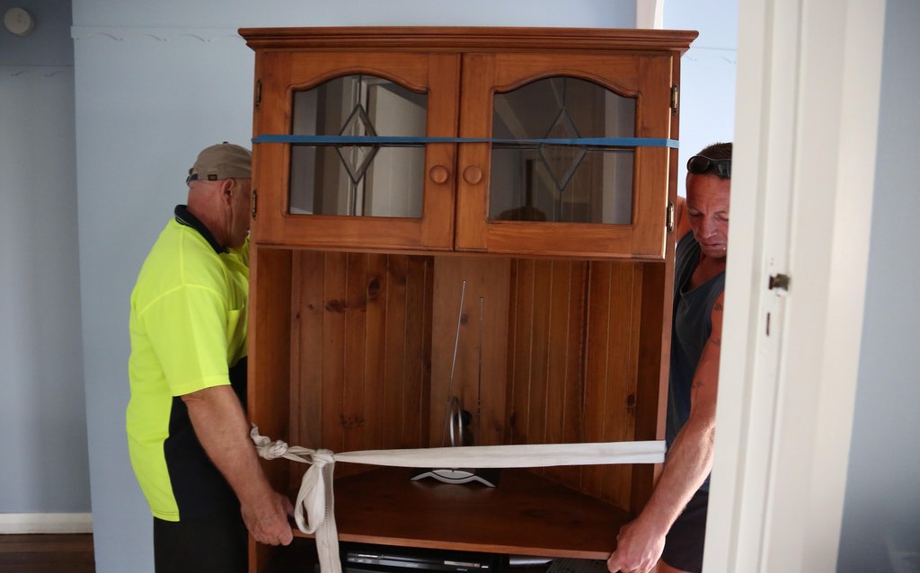 men lifting cupboard
